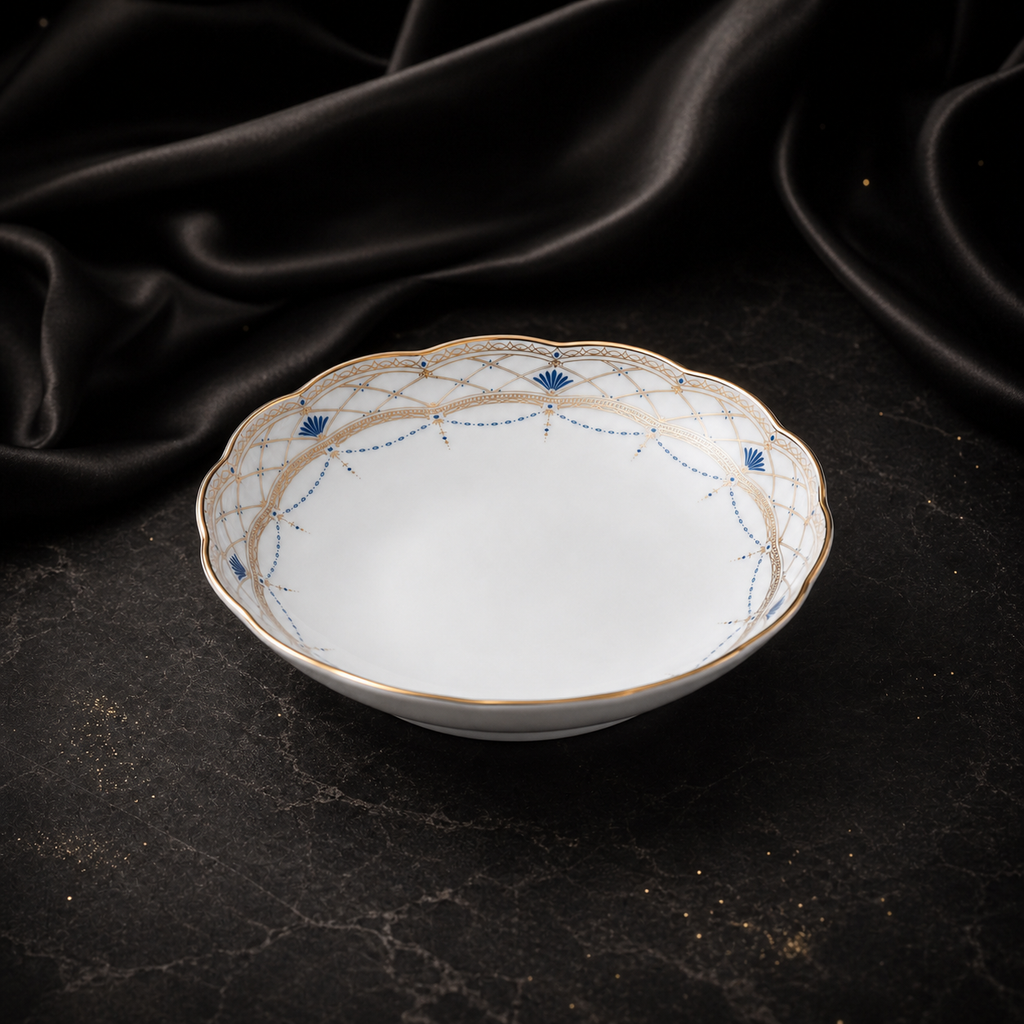 Front three-quarter view of the Valesse Azure fruit bowl showing its shallow depth, footed base and blue-and-gold rim.