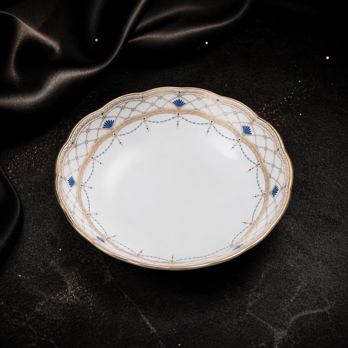 High-angle view of the empty Valesse Azure 14.9 cm fruit bowl with its luminous white interior and ornate blue-and-gold border.