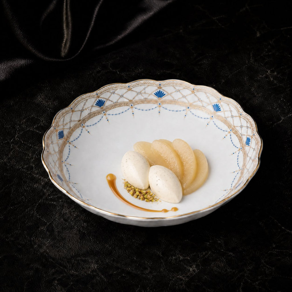 Overhead view of the empty Valesse Azure fruit bowl, showing the white interior framed by blue motifs and fine gold latticework.