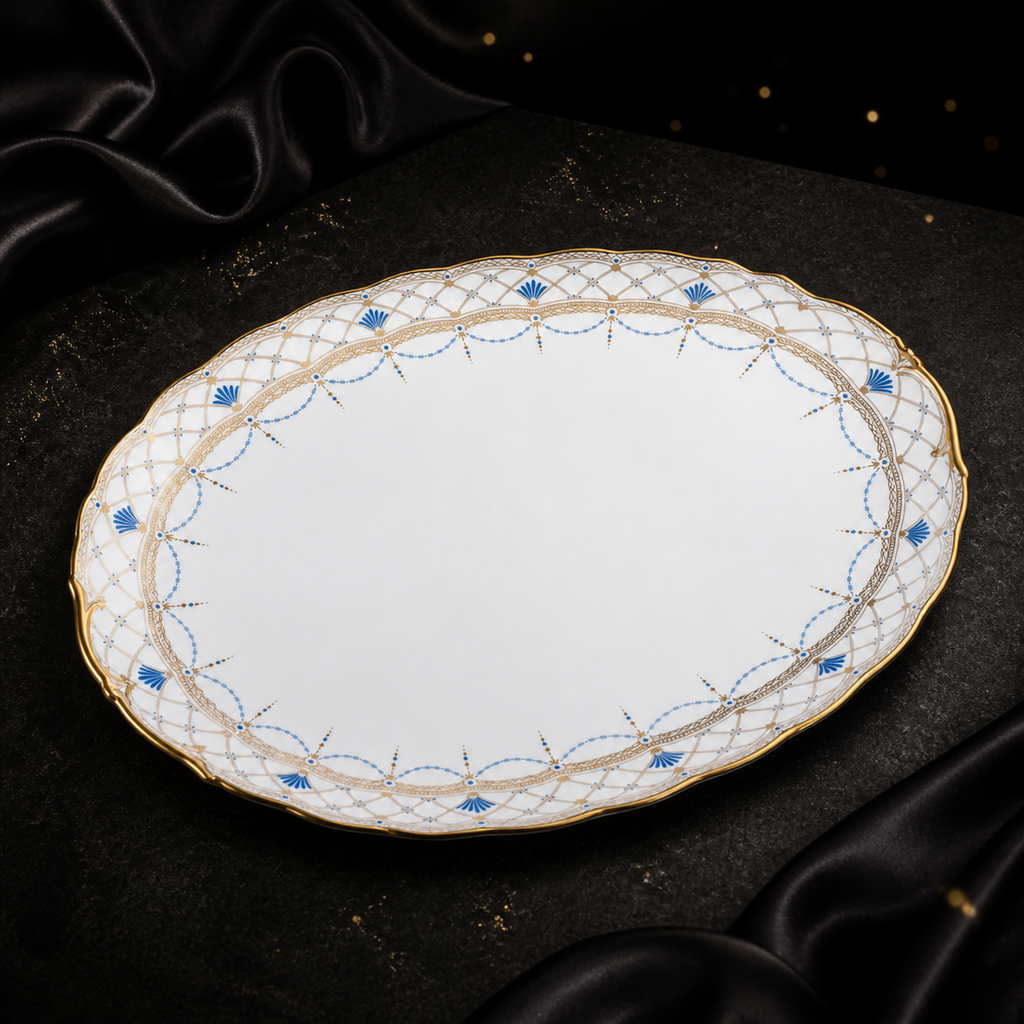Angled top view of the empty Valesse Azure 33 cm oval platter with blue motifs, gold latticework and a shaped rim.