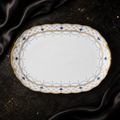 Top view of the Valesse Azure 33 cm oval platter in white bone china with ornate blue-and-gold border detailing.