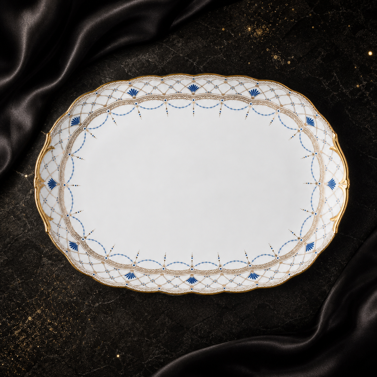 Top view of the Valesse Azure 33 cm oval platter in white bone china with ornate blue-and-gold border detailing.