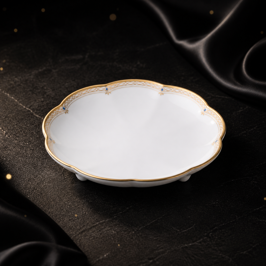 Three-quarter view of the empty Valesse Azure 9.1 cm petit dish on a dark stone surface with black satin styling.