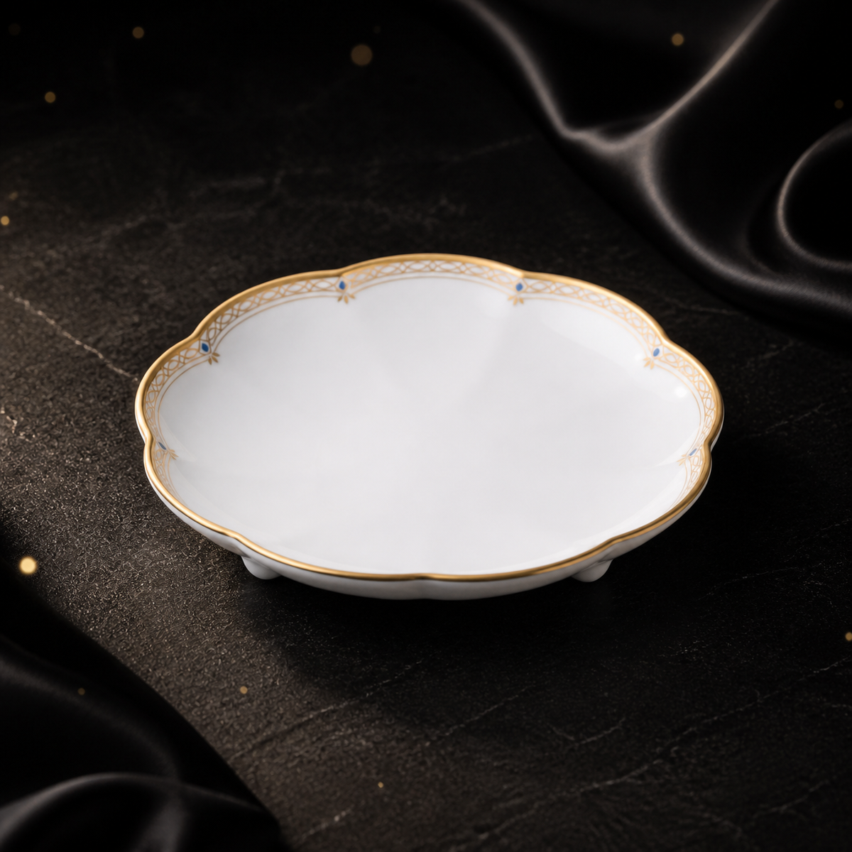Three-quarter view of the empty Valesse Azure 9.1 cm petit dish on a dark stone surface with black satin styling.