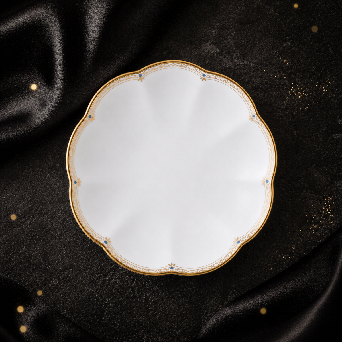 Top view of the Valesse Azure 9.1 cm petit dish in white bone china with a scalloped gold rim and blue accents.
