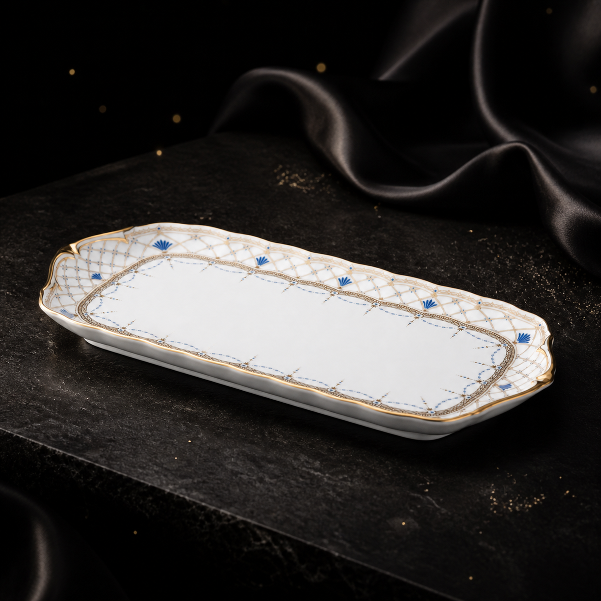 Low three-quarter view of the Valesse Azure 23 cm small tray highlighting the shallow bone-china profile and gold-edged rim.