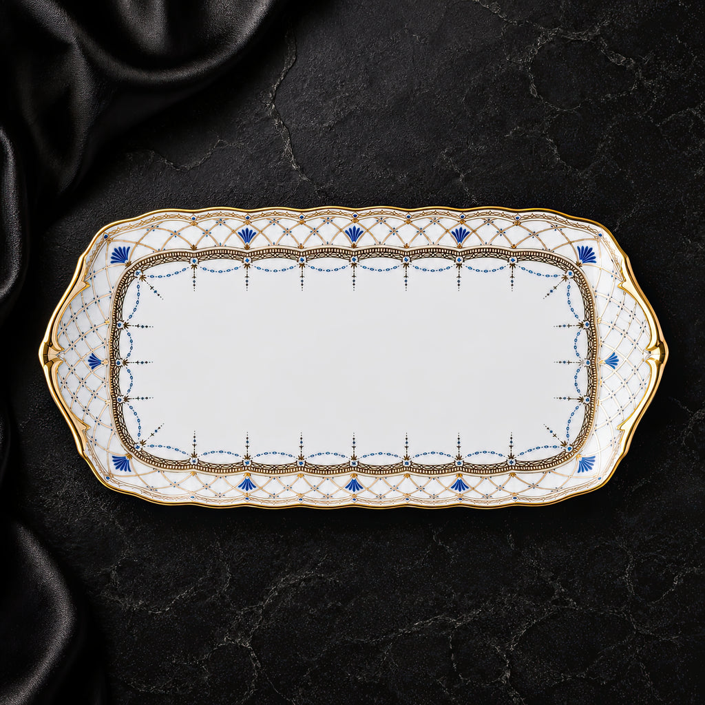 Top view of the Valesse Azure 23 cm small tray, showing its elongated white bone-china form and intricate blue-and-gold border.